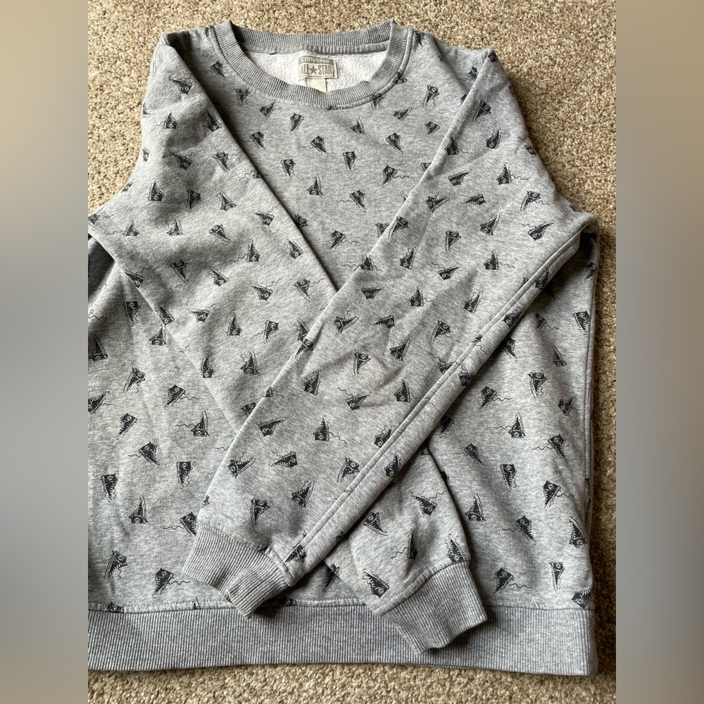 The cutest converse sweater with converse shoe logos on it.